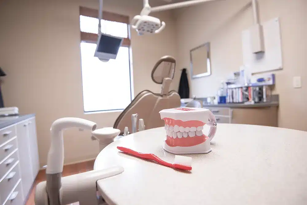 Inside view of our Plano dental office with a custom tooth mold and tooth brush on the table.